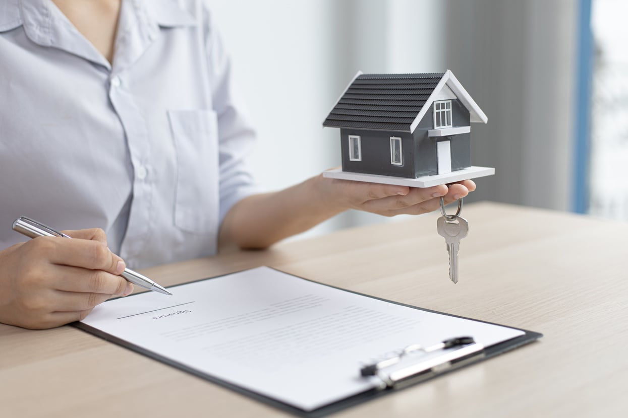 Real Estate Agent Signing a Document           